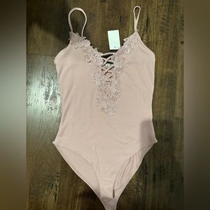 Pink body suit. Size: S . New with tag.